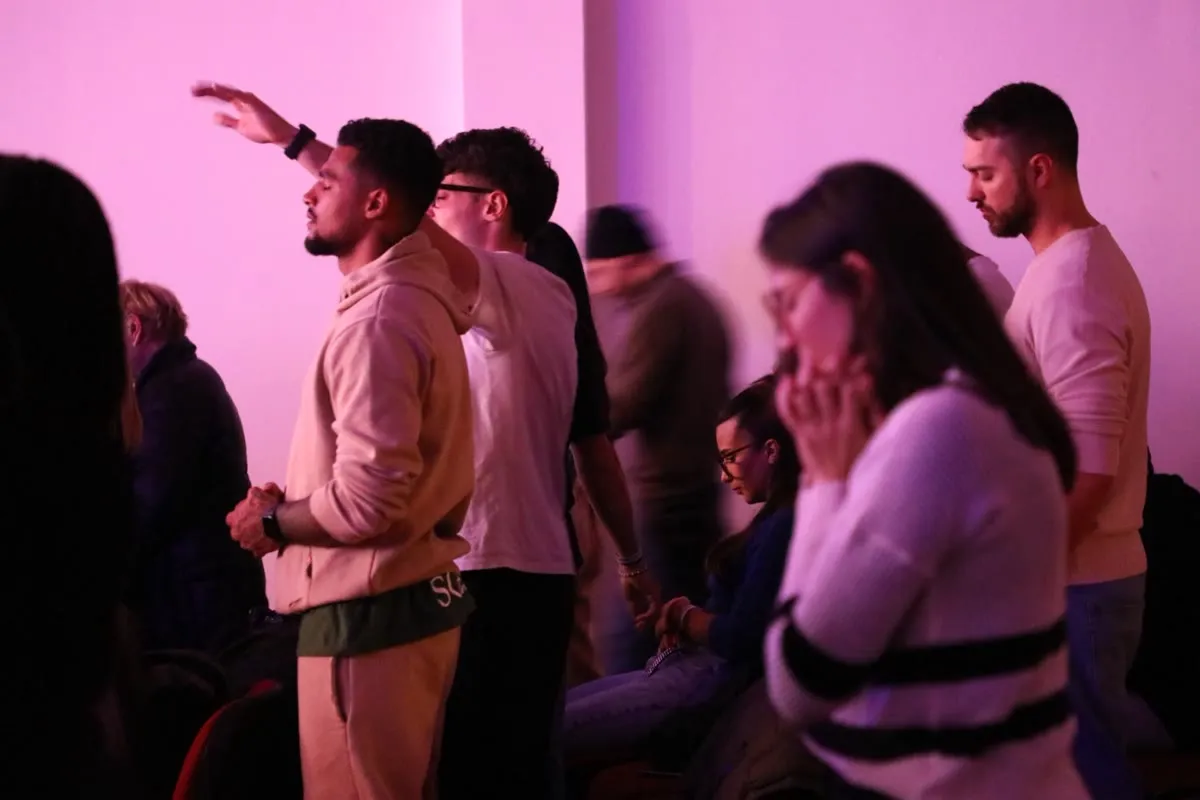 Church members praying during worship